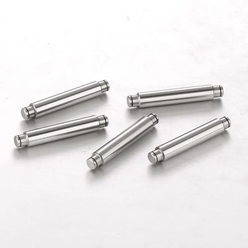 Short precision pins with grooves on a light background