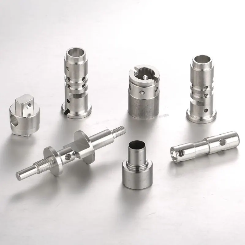 Silver-coloured turned parts with cross holes