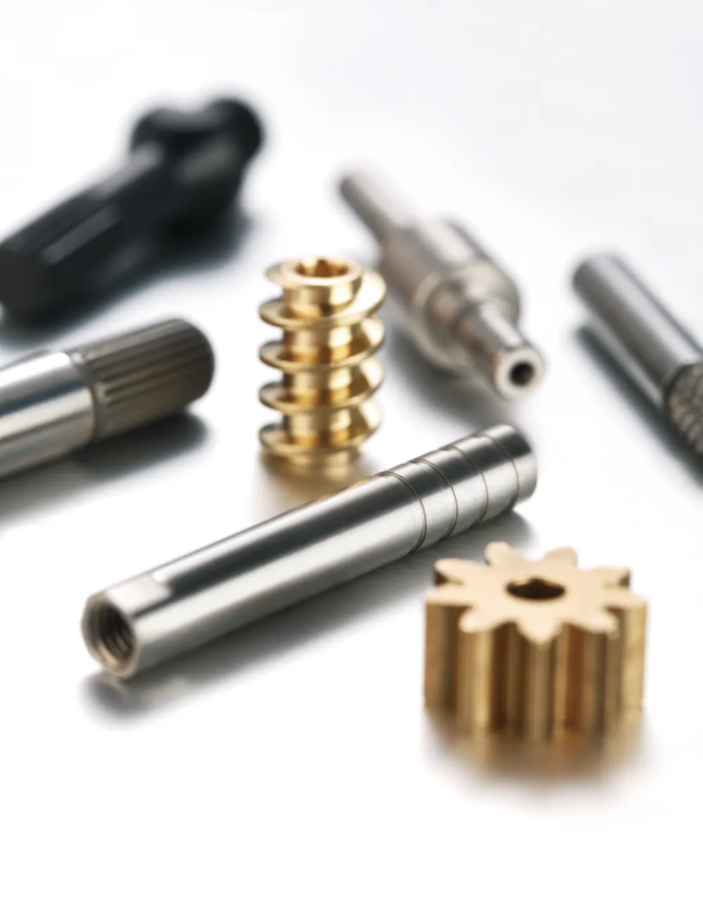 Close-up of a gold-coloured worm and gear with knurled shafts